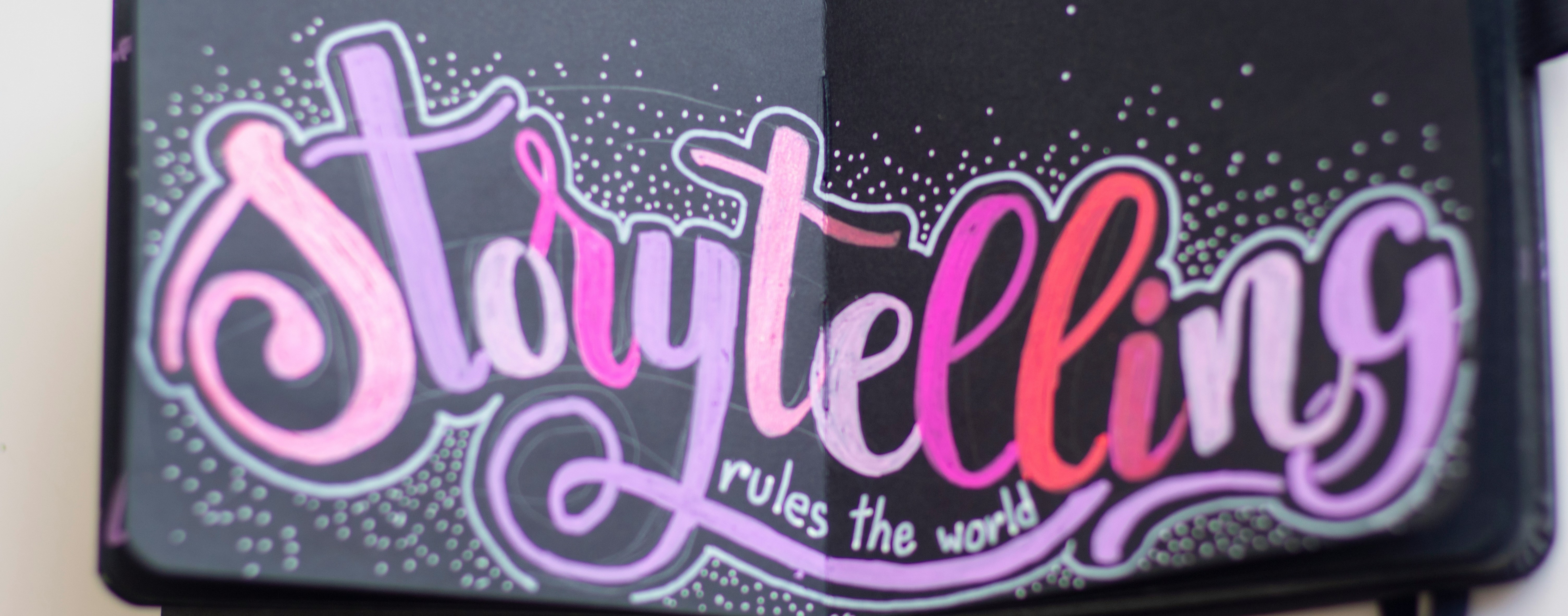Image of book with the handwritten words saying Storytelling rules the world